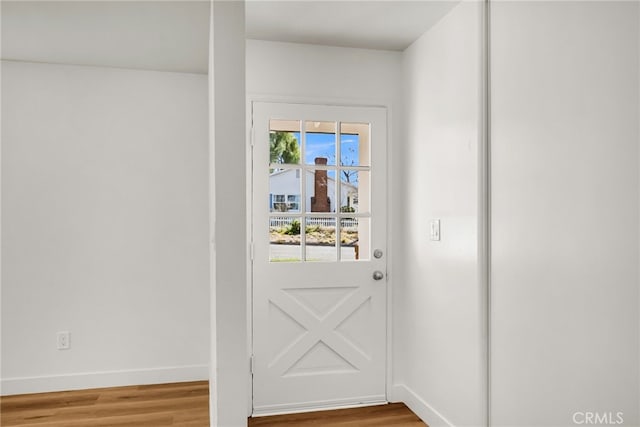 entryway with baseboards and wood finished floors