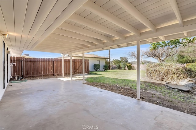 view of patio featuring an attached carport and fence