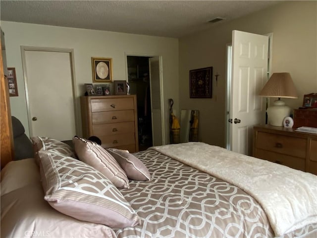 bedroom with visible vents and a textured ceiling