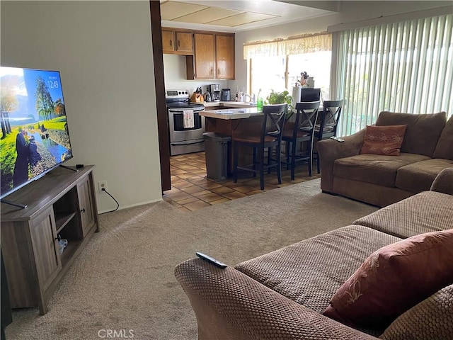 living area with light carpet and light tile patterned floors