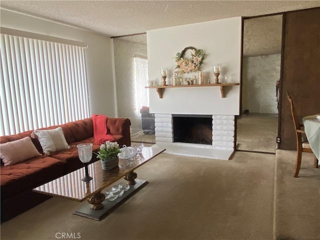 carpeted living room with a healthy amount of sunlight, a brick fireplace, and a textured ceiling