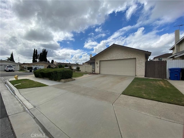 ranch-style home with a garage, concrete driveway, stucco siding, and fence