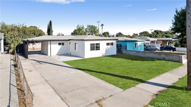 ranch-style house with a carport, concrete driveway, a front yard, and fence