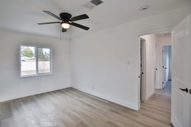 unfurnished room featuring visible vents, baseboards, a ceiling fan, and light wood finished floors