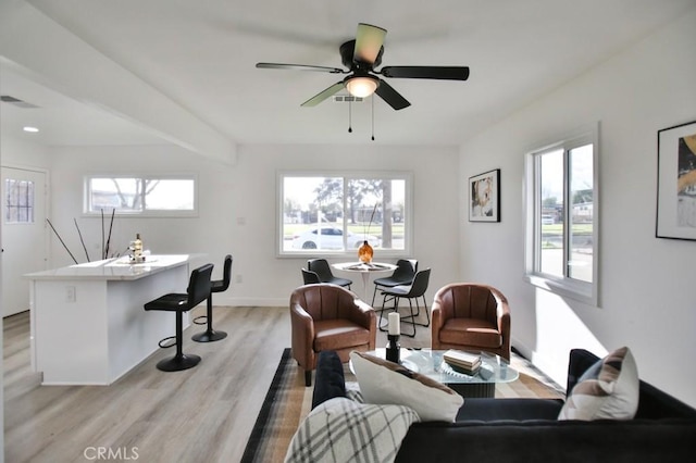 living room featuring visible vents, a healthy amount of sunlight, and light wood-style flooring