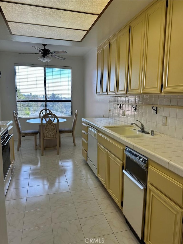 kitchen with tile countertops, tasteful backsplash, stove, and white dishwasher