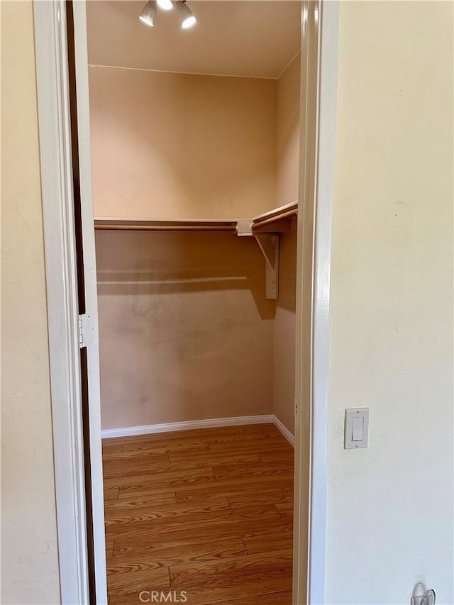 spacious closet with wood finished floors