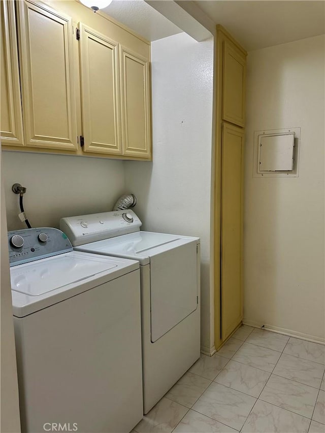 laundry area with cabinet space, marble finish floor, and washing machine and clothes dryer