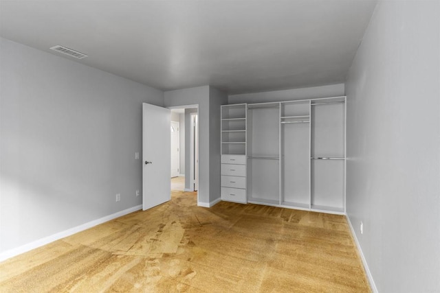 unfurnished bedroom featuring a closet, visible vents, carpet flooring, and baseboards