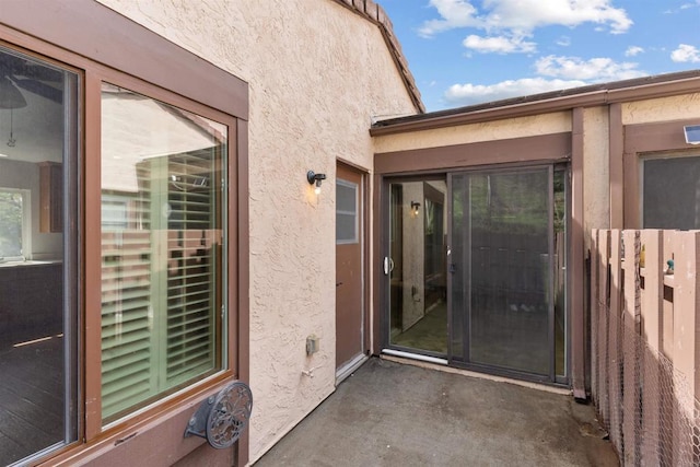 entrance to property with stucco siding