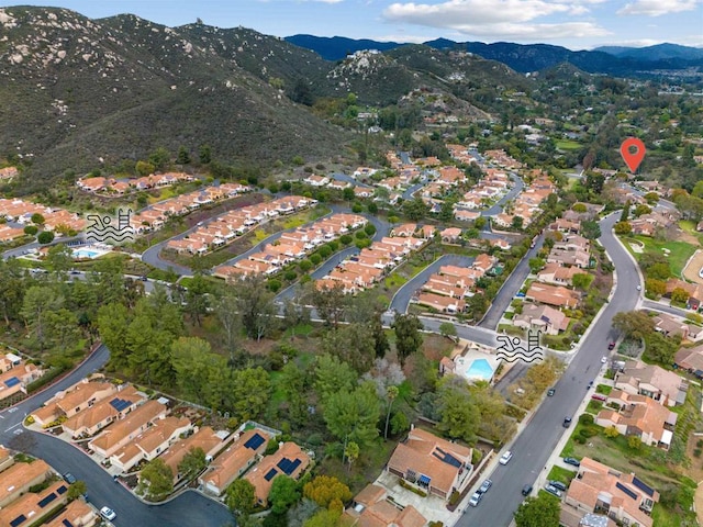 birds eye view of property with a mountain view and a residential view