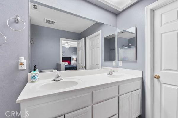 full bath featuring double vanity, visible vents, ensuite bath, and a sink