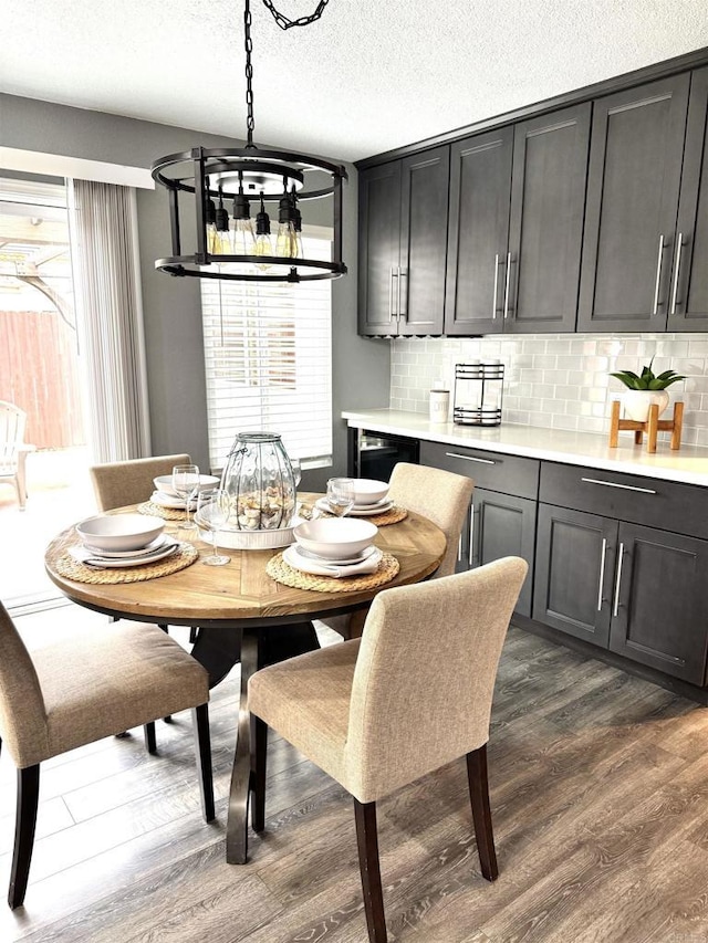 dining area featuring dark wood finished floors and a textured ceiling