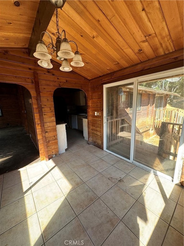 unfurnished sunroom with an inviting chandelier, wooden ceiling, arched walkways, and lofted ceiling