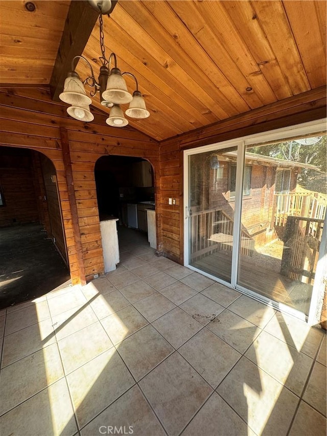 unfurnished sunroom with arched walkways, a chandelier, wood ceiling, and vaulted ceiling