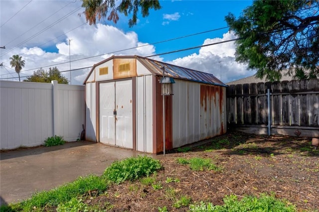 view of shed with a fenced backyard