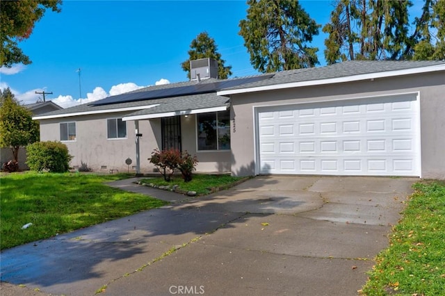 ranch-style home with stucco siding, a front lawn, concrete driveway, an attached garage, and solar panels