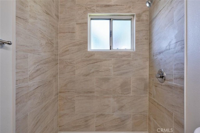 bathroom with a tile shower