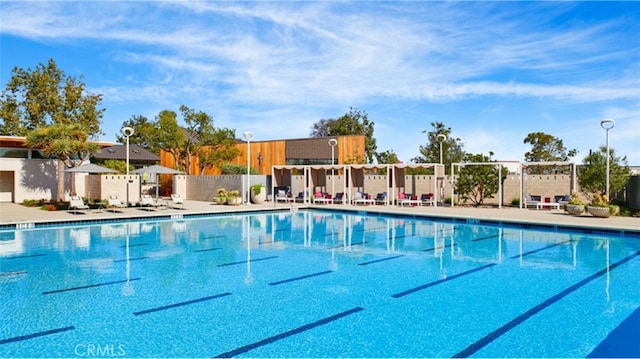 community pool featuring a patio and fence