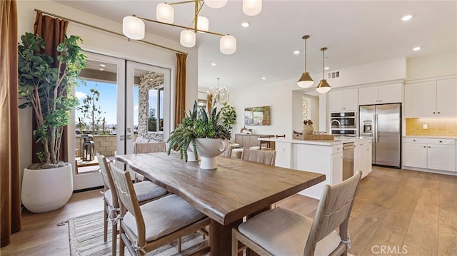 dining area featuring recessed lighting, french doors, visible vents, and light wood-style flooring