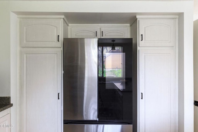 kitchen featuring dark countertops, white cabinetry, and smart refrigerator