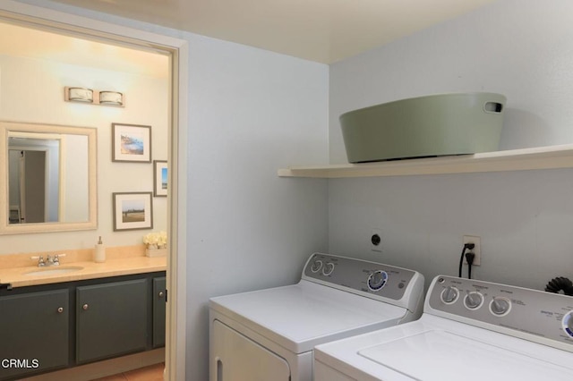 laundry area featuring a sink, laundry area, and separate washer and dryer