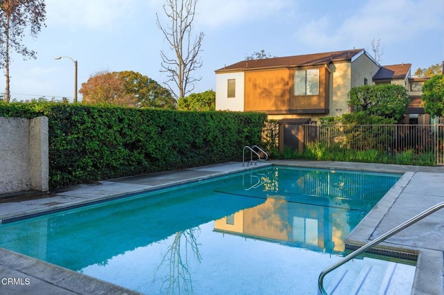 view of swimming pool featuring a fenced in pool and fence