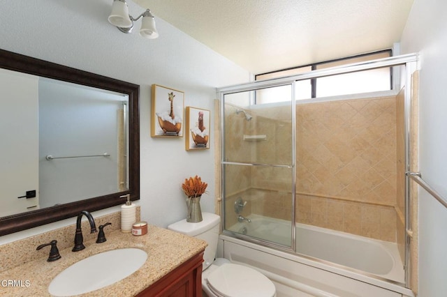 bathroom with vanity, toilet, bath / shower combo with glass door, and a textured ceiling