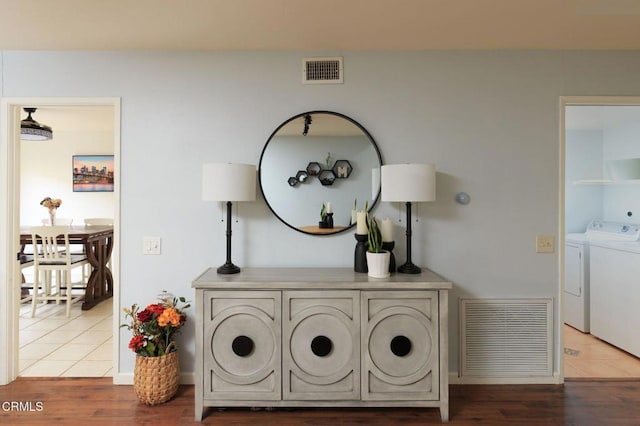 details featuring visible vents, independent washer and dryer, and wood finished floors