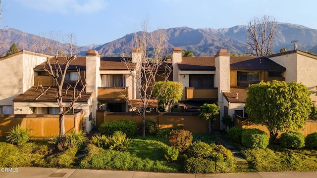 exterior space featuring a mountain view and a fenced front yard