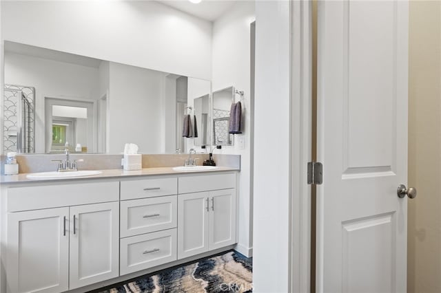 full bathroom with a sink and double vanity