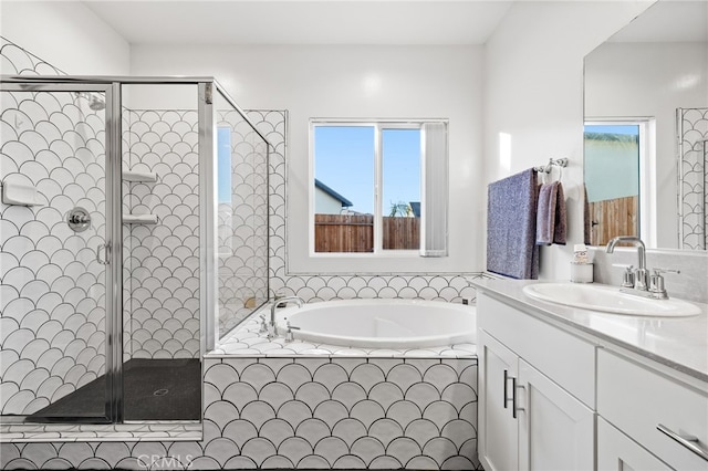 full bathroom with vanity, a shower stall, and a bath