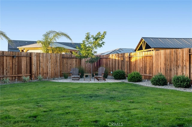 view of yard with a fenced backyard and a patio area