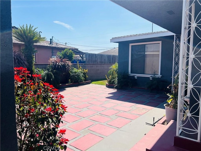 view of patio / terrace featuring fence