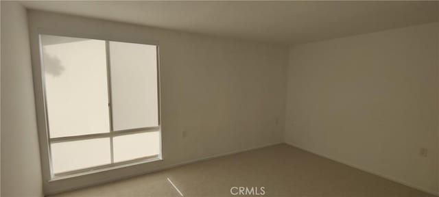 empty room with carpet and baseboards