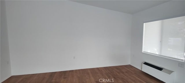 unfurnished room with wood finished floors