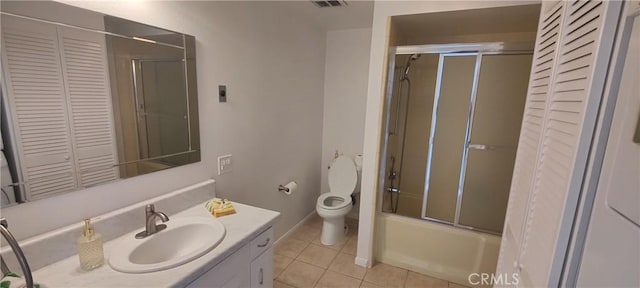 bathroom featuring vanity, tile patterned floors, combined bath / shower with glass door, and a closet