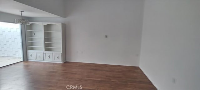 unfurnished room with wood finished floors