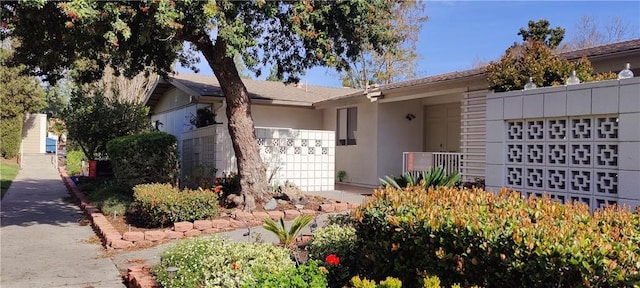 471 Calle Cadiz Unit G, Laguna Woods, CA 92637 - view of front of property with a garage and stucco siding