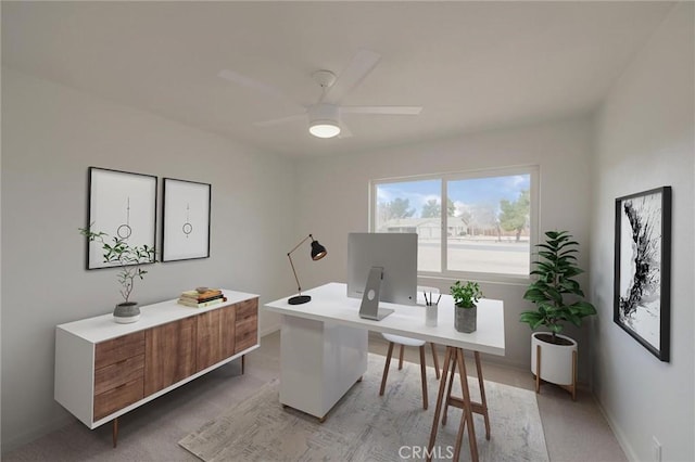 office with light colored carpet, baseboards, and ceiling fan