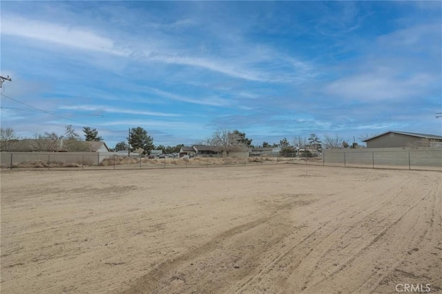 view of yard featuring a rural view and fence