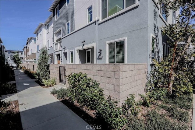 view of side of property with a fenced front yard and a residential view