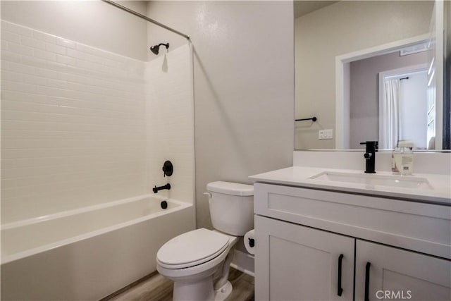 bathroom with bathtub / shower combination, wood finished floors, toilet, and vanity