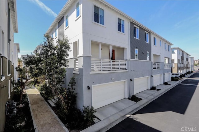 view of property featuring a garage and a residential view