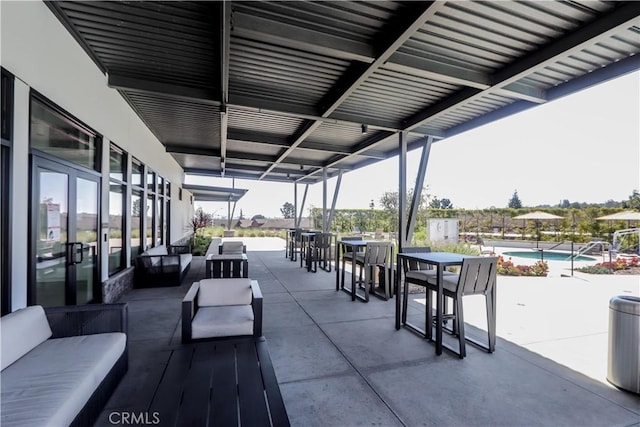 view of patio with an outdoor pool, outdoor dining space, and outdoor lounge area