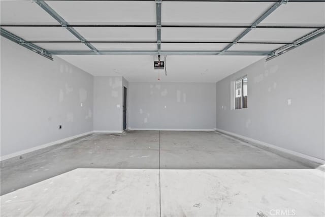 garage with a garage door opener and baseboards