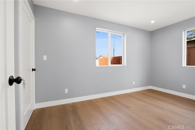 unfurnished bedroom with recessed lighting, baseboards, and wood finished floors