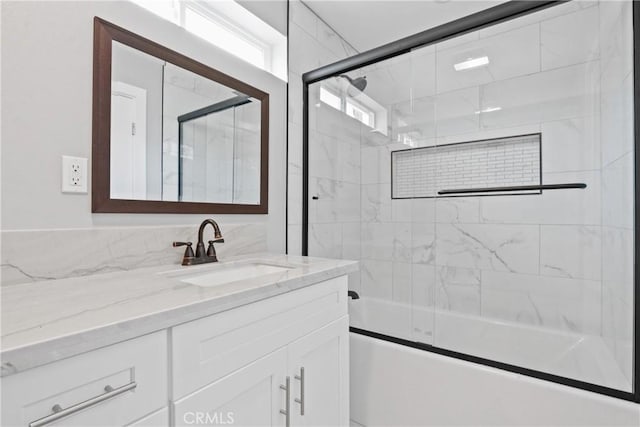 full bathroom with enclosed tub / shower combo and vanity