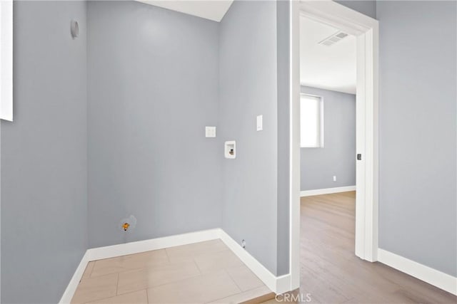 laundry room with visible vents, baseboards, wood finished floors, and laundry area