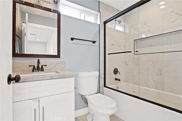 bathroom featuring enclosed tub / shower combo, toilet, and vanity